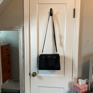 Kate spade black with gold accent leather handbag.